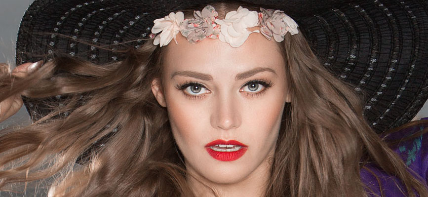 Young woman in hat with long hair