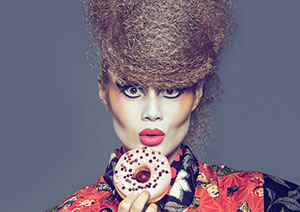 Young woman in kimono eating a donut